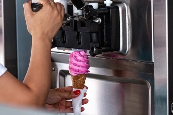 A person making Ice cream with an Ice Cream Machine