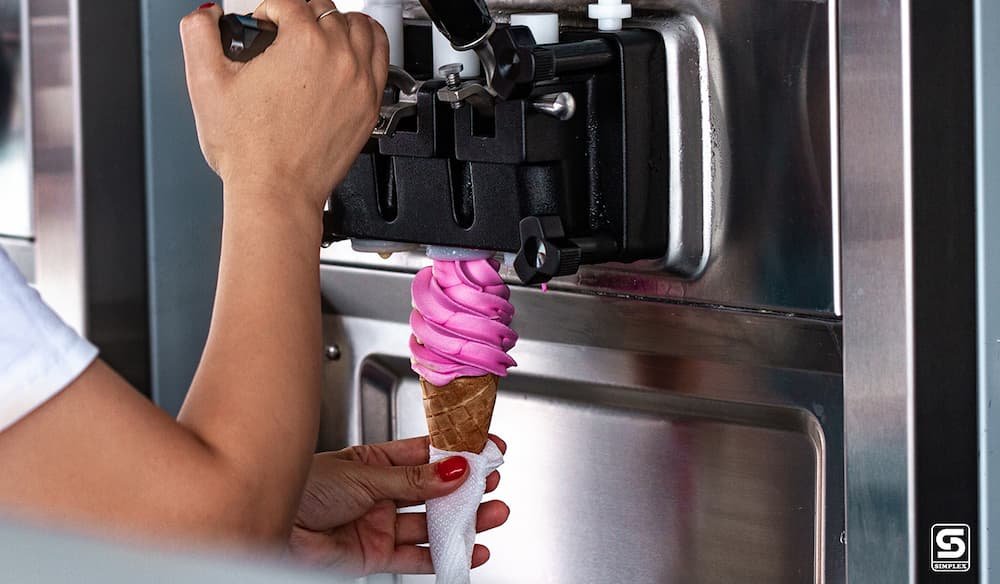 A person making Ice cream with an Ice Cream Machine